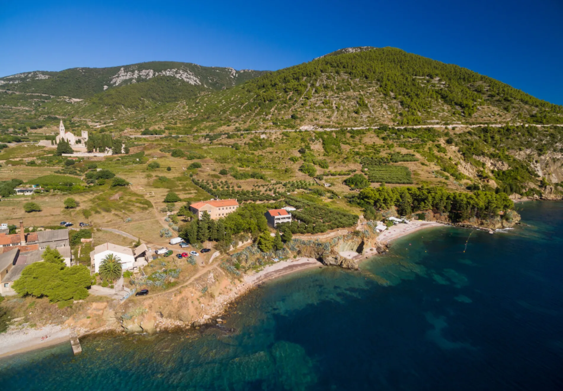 Aerial view of beach, Saint Nicholas Church and surrounding on Vis Island in Komiza town