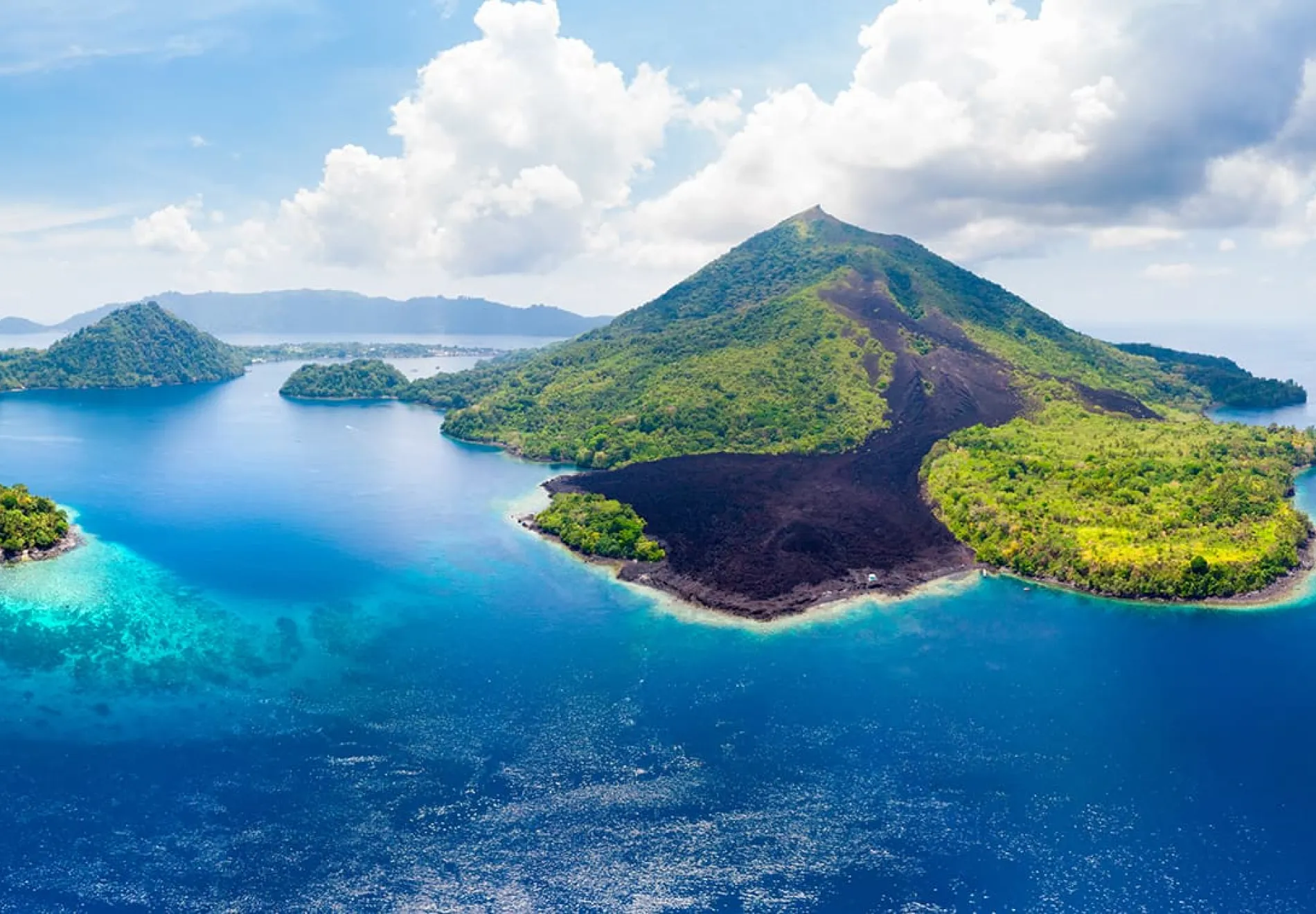 Aerial-view-Banda-Islands-Moluccas-archipelago-Indonesia-Pulau-Gunung-Api-lava-flows-coral-reef-white-sand-beach.-Top-travel-tourist-destination-best-diving-snorkeling