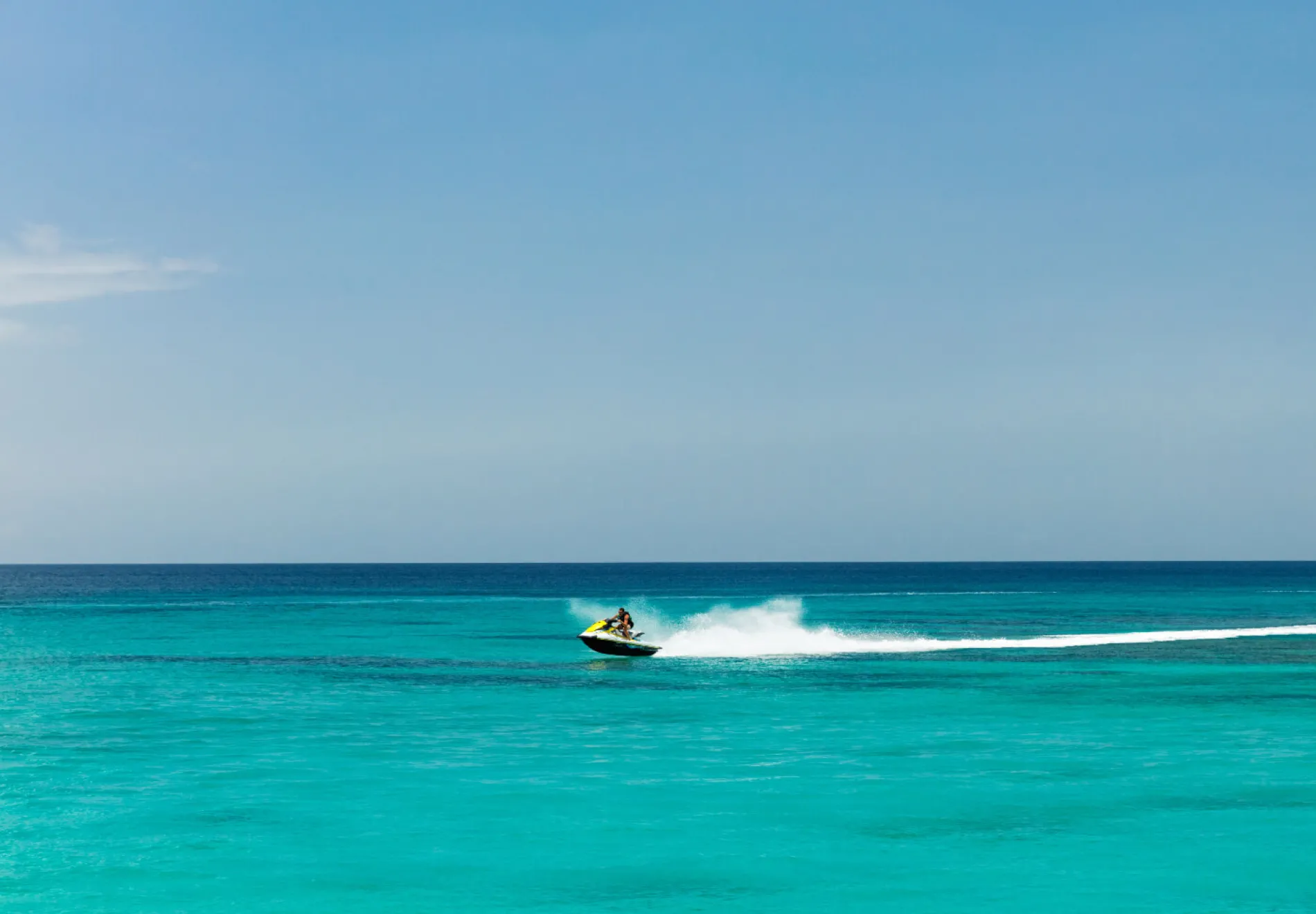 Jet ski rider on tropical pristine beach in Barbados, Caribbean