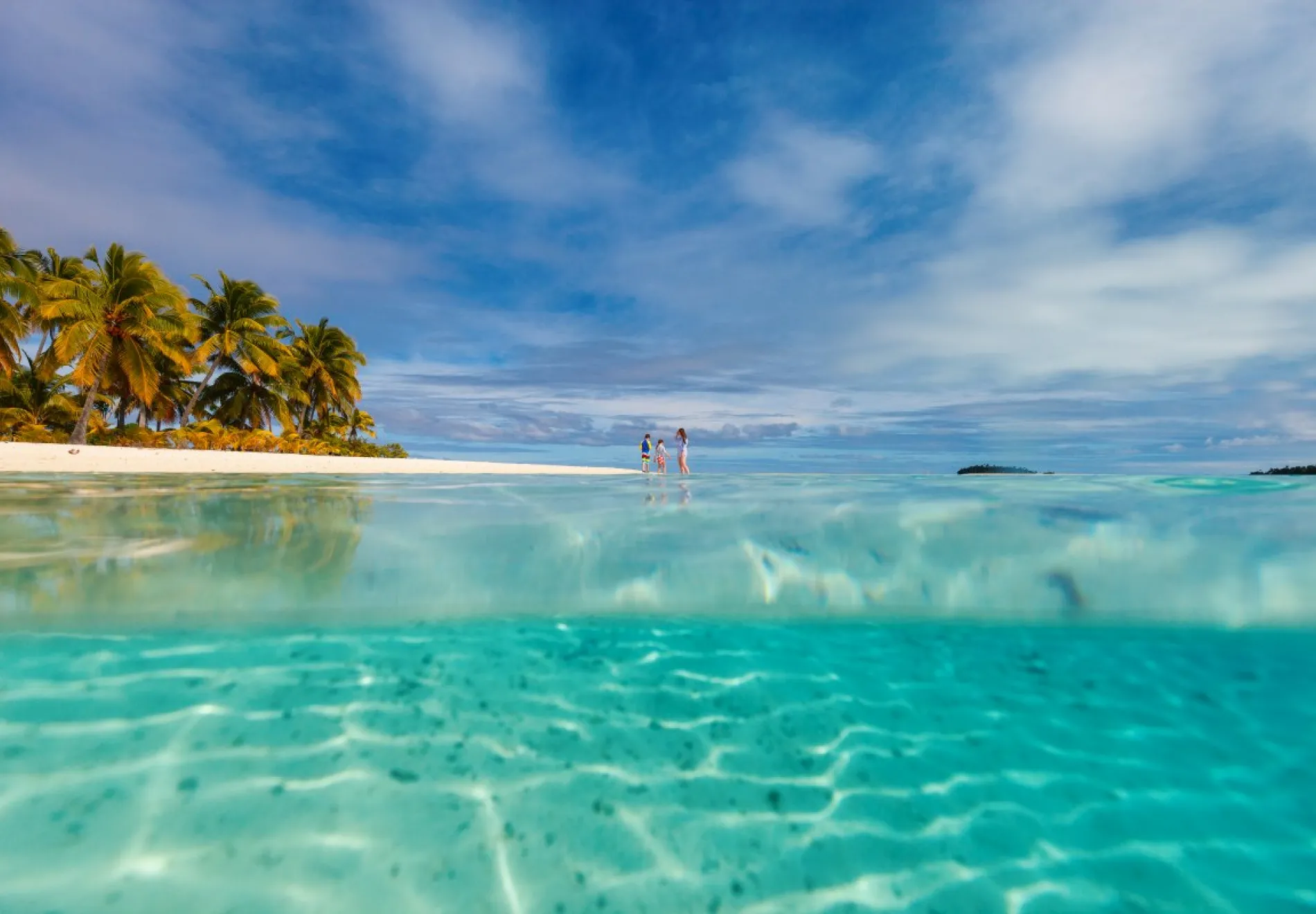 Mother-and-kids-family-at-tropical-beach-Cook-island