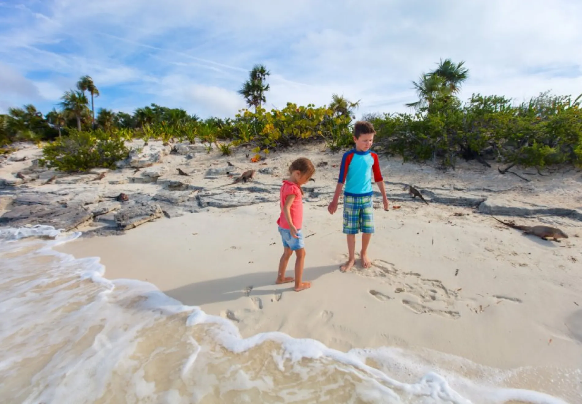Two kids at beach of Iguana island