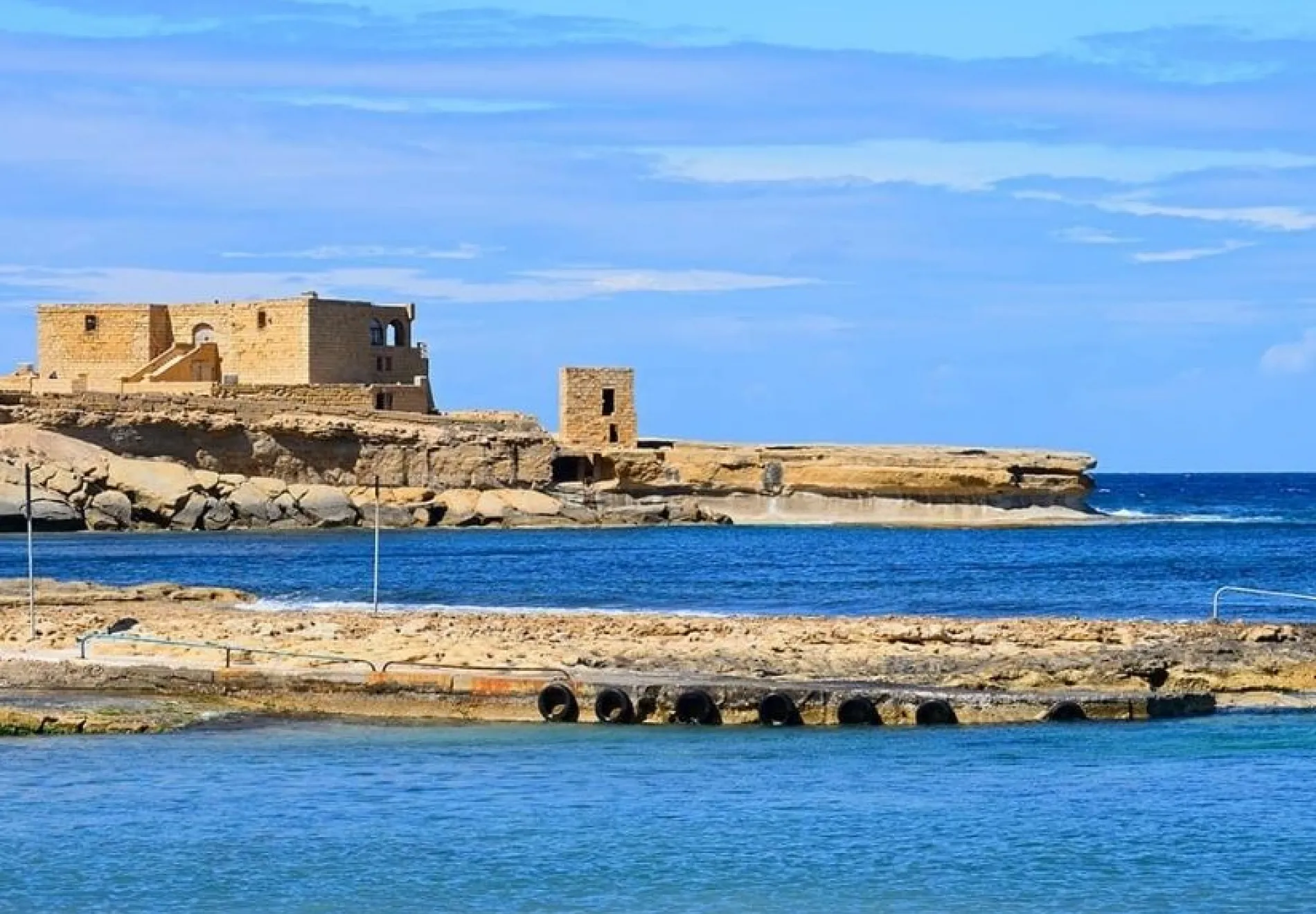 View-along-the-rugged-coastline-towards-the-Il-Qolla-I-Badja-battery-Redoubt-Marsalforn-Gozo-Malta-1 CROP