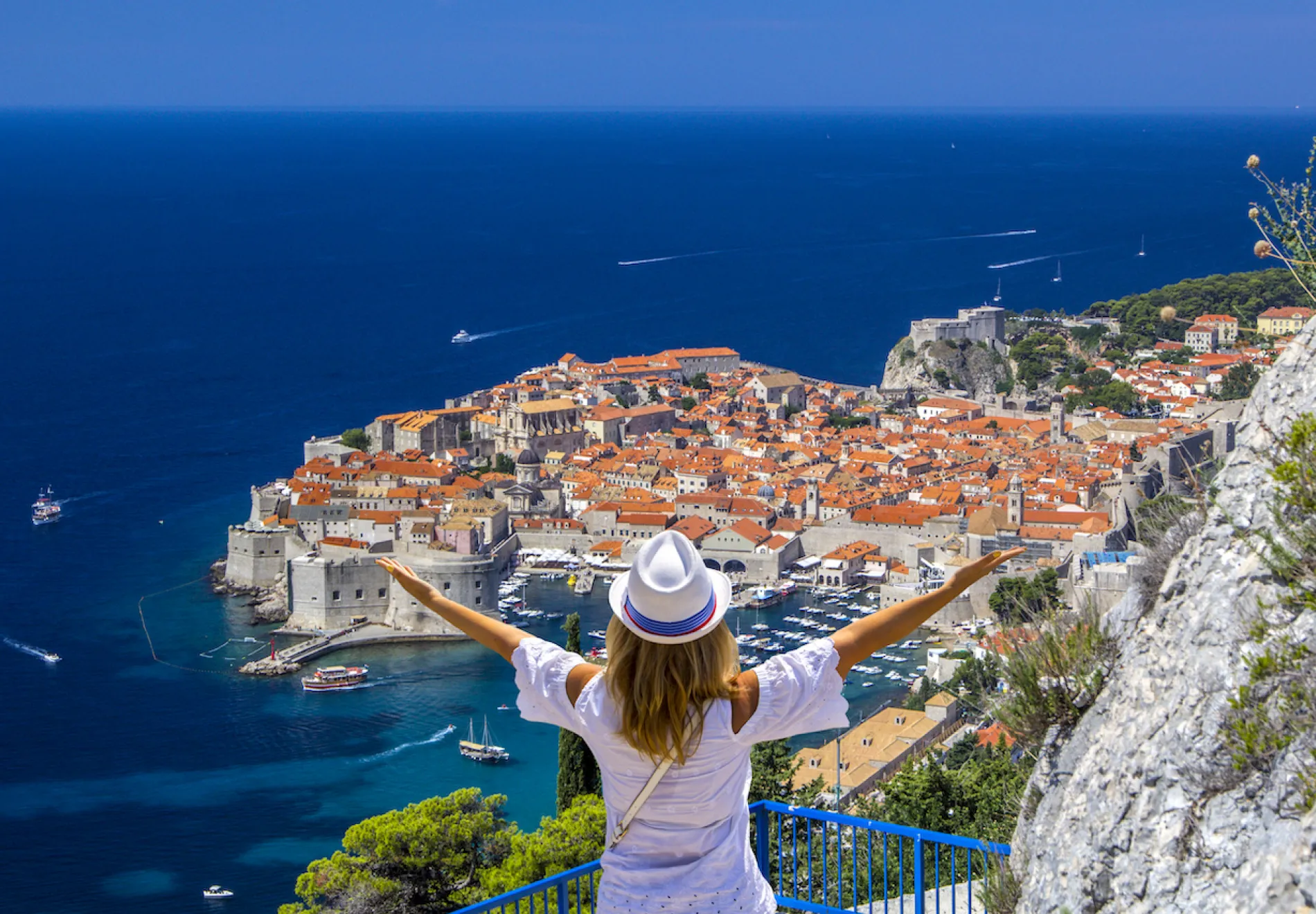 Happy-Girl-Enjoys-View-Of-Old city of Dubrovnik